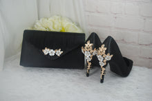 Load image into Gallery viewer, a pair of shoes and a purse on a table