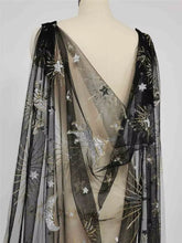 Load image into Gallery viewer, a mannequin wearing a black and gold sheer dress with a star and crescent pattern. The dress has long, flowing sleeves and a cape-like design, creating a dramatic and elegant appearance.