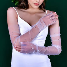 Load image into Gallery viewer, a woman wearing a white dress and a white veil