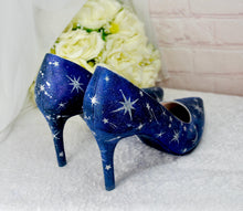 Load image into Gallery viewer, a pair of blue high heeled shoes next to a bouquet of white roses

