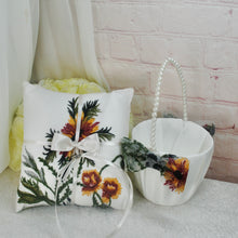 Load image into Gallery viewer, a white basket with flowers on it next to a pillow
