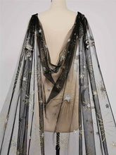 Load image into Gallery viewer, A mannequin wearing a black sheer dress with gold star and moon embroidery.
