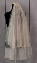 Load image into Gallery viewer, A mannequin wearing a white, sheer veil with a gold crown on its head.
