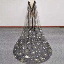 Load image into Gallery viewer, A long, flowing black and gold veil with a starry and moon-like pattern, displayed on a mannequin.
