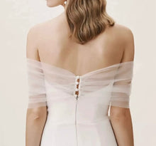 Load image into Gallery viewer, a woman wearing a white dress with sheer sleeves
