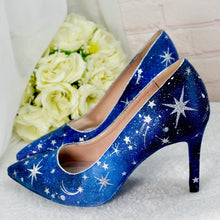 Load image into Gallery viewer, a pair of blue high heeled shoes next to a bouquet of white roses
